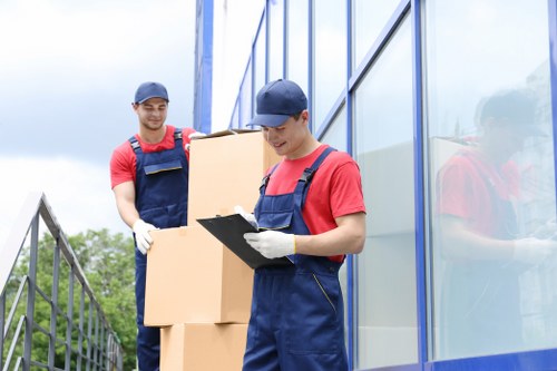Staff loading a van safely with moving equipment